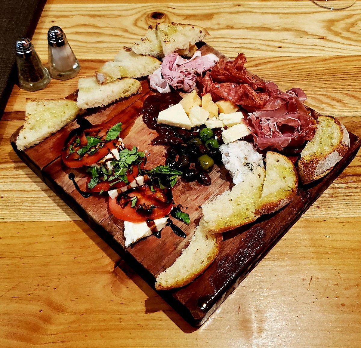 M'tucci's Italian Restaurant signature dishes Five Pork Bolognese24-ounce Bone-in RibeyeHouse-Cured Charcuterie BoardPan-Seared Scallops